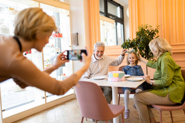 Grandparent spending time with granddaughter at cafe