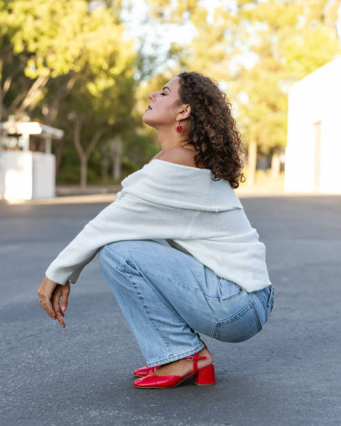 istock Young woman in cozy off shoulder white sweater 2189629663