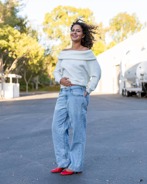 istock Young woman in cozy off shoulder white sweater 2189629763