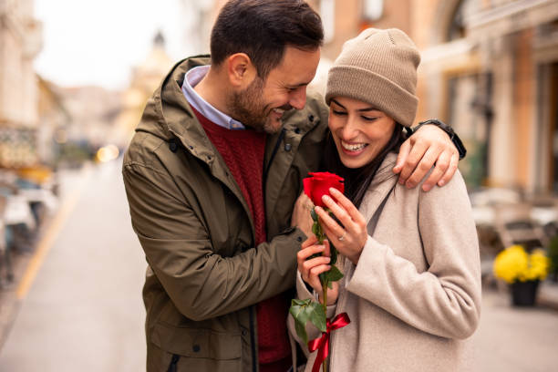 istock Happy Caucasian Man Surprises Partner with Rose 2189634082