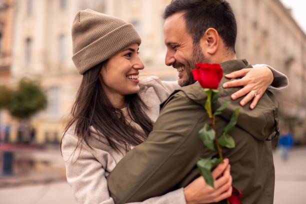 istock Caucasian Male Joyfully Surprises Partner with Rose 2189634086
