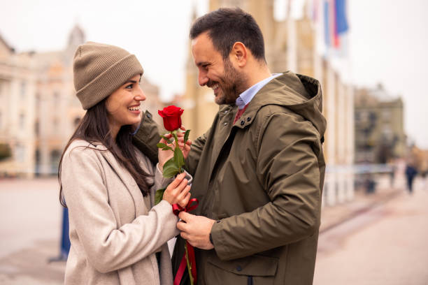istock Caucasian Male Joyfully Surprising Partner with Rose 2189634107