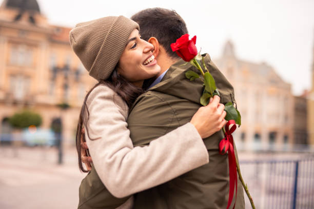 istock Caucasian Man Joyfully Surprising Partner with a Rose 2189634155
