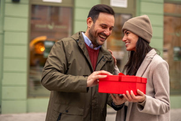 istock Joyful Caucasian Couple Celebrating with Gift Exchange 2189634164