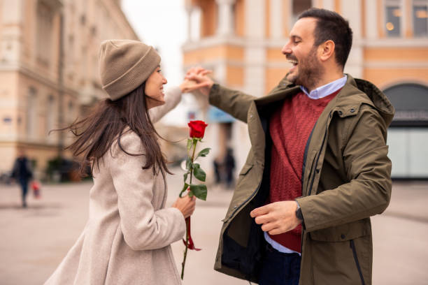 Caucasian Couple Joyfully Dancing and Sharing a Romantic Gesture