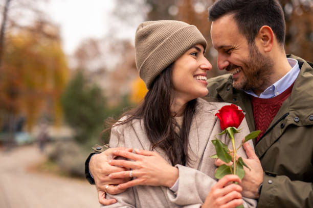 istock Caucasian Couple Joyfully Embracing in Public Park 2189634574