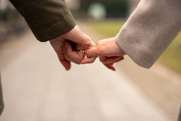 istock Romantic Diverse Couple Holding Hands Joyfully Strolling 2189634606