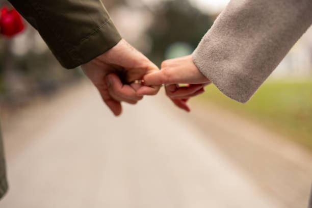 istock Caucasian Couple Joyfully Sharing a Tender Moment Holding Hands 2189634644