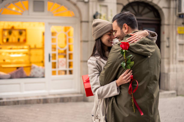 istock Joyful Diverse Couple Embracing with Gift Exchange 2189634673