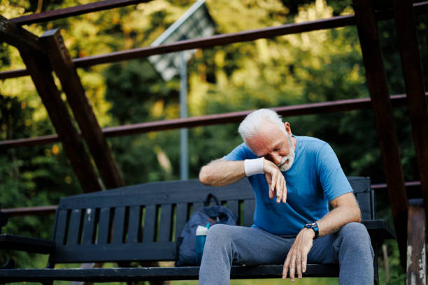 istock Tired senior sporty man resting on park bench 2189637642