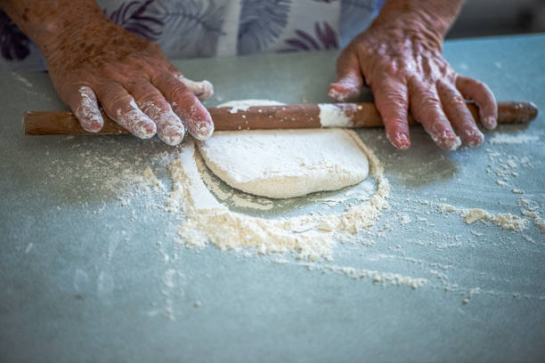 istock Elderly Woman Rolling Out Dough 2189639703