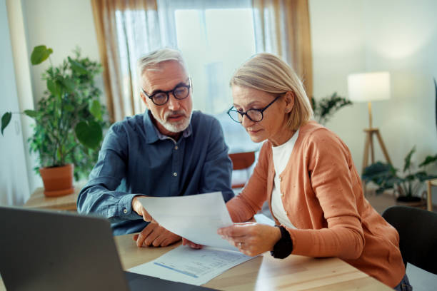istock Mature couple going over bills at home 2189640158