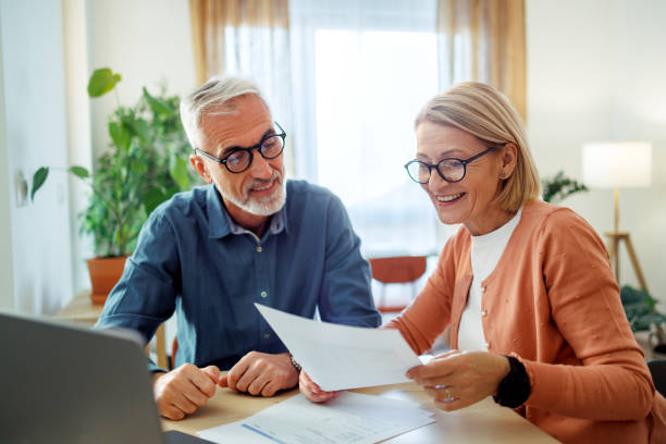 istock Mature couple going over bills at home 2189640159
