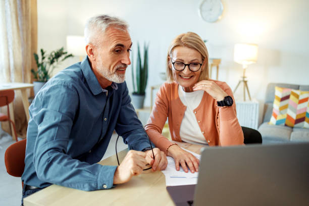 istock Mature couple going over bills at home 2189640160