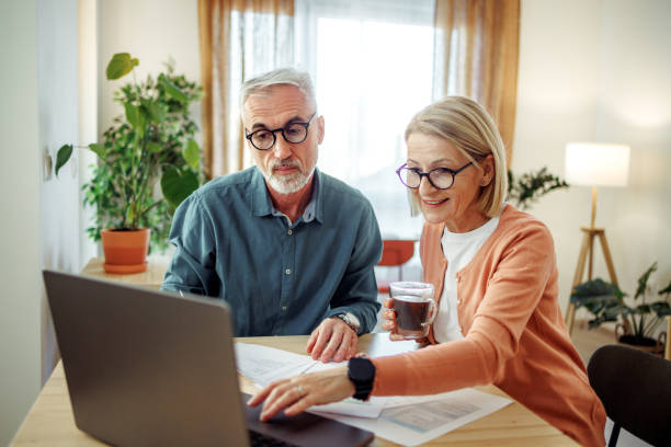 istock Well dressed mature couple going over paperwork at home 2189640178