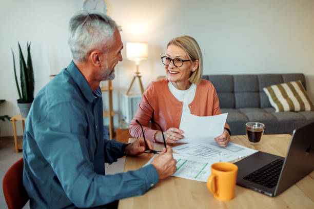 istock Mature couple having discussion over bills while using laptop at home 2189640181