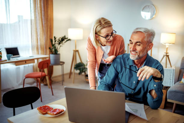 istock Mature woman checking on her working husband at the home 2189640242