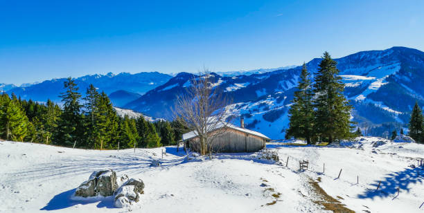 istock Alpine panorama with snowy mountain hut 2189640327