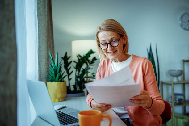 istock Mature woman using laptop at home 2189640913
