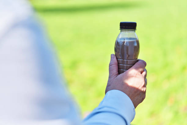 Drinking Coffee Latte from Recycled PET Plastic Bottle Outside