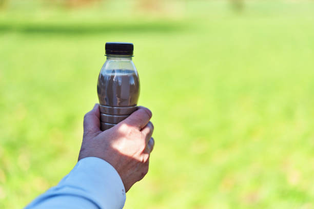 istock Drinking Coffee Latte from Recycled PET Plastic Bottle Outside 2189641205