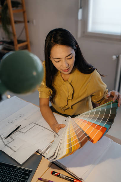 istock Designer Reviewing Color Palettes in a Modern Workspace 2189641561