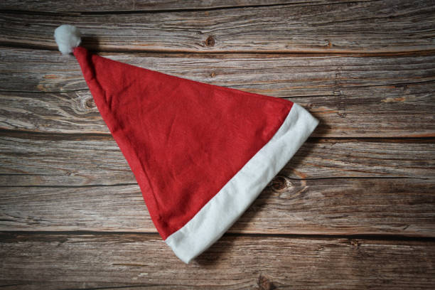 Santa hat isolated on wooden background with text space