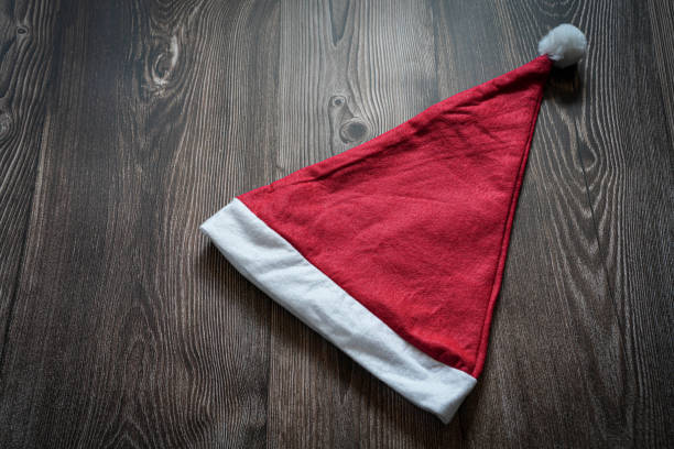 Santa hat isolated on wooden background with text space