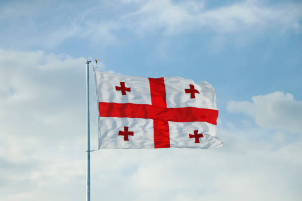 istock georgian flag waving in the sky with blue background 2189642139