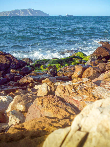 rocks on the sea coast, photo as a background, digital imageDirt road leading to the sea on a sunny summer day.