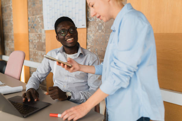 istock Colleagues Discussing files on laptop in a Modern Office 2189643579