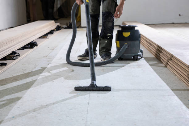 istock Worker Prepares Floor for Wooden Floorboard Installation Indoors 2189643734