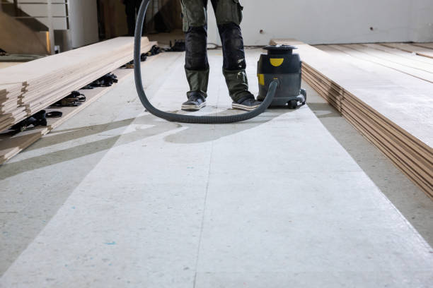 istock Worker Prepares Subfloor for Wooden Floorboard Installation Indoors 2189643736