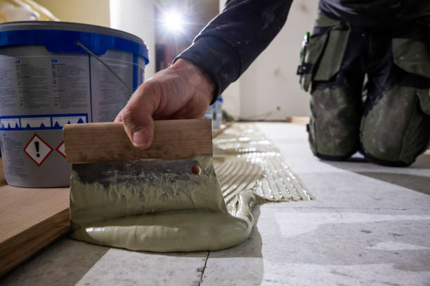 istock Close Up of Floorboard Installation with Adhesive Application 2189643821