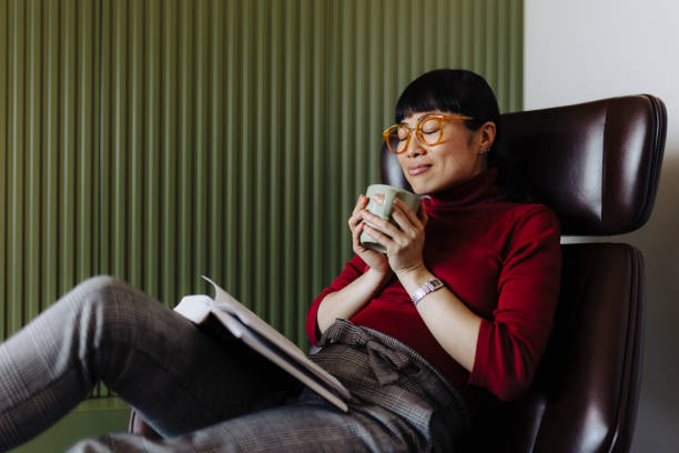 istock Woman resting at home and reading book 2189646784
