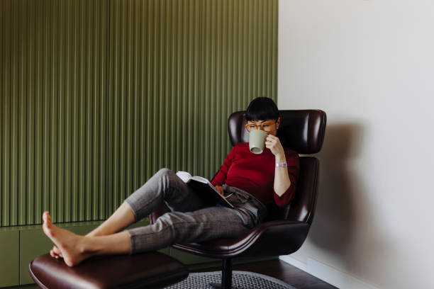 istock Woman resting at home and reading book 2189646929