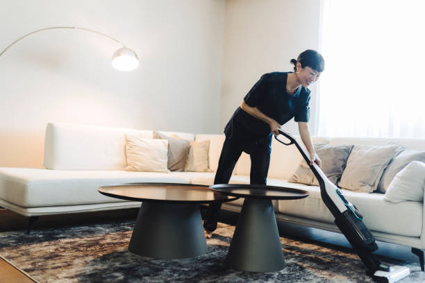 istock Housekeeper Cleaning Carpet With Vacuum Cleaner 2189647268