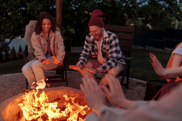 istock A group of friends warming their hands over a campfire 2189650963