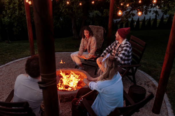 istock Friends enjoying the warmth of a campfire 2189650967