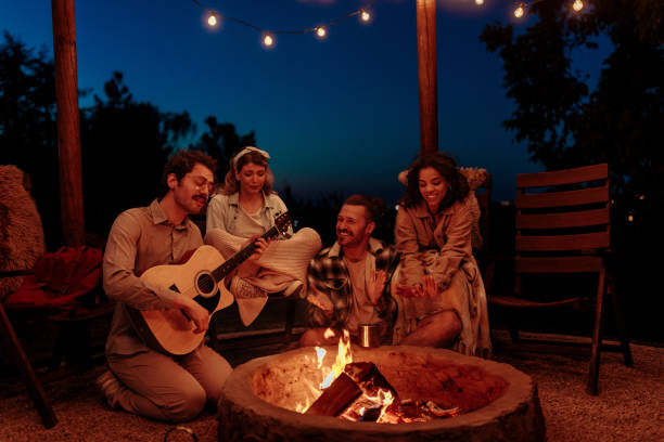 istock Friends enjoying guitar music by a campfire 2189650969