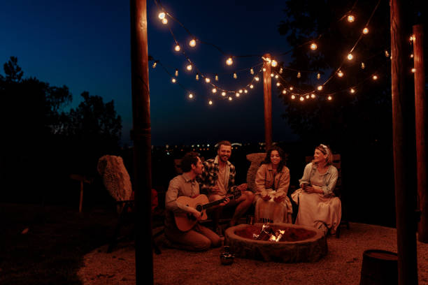 istock Friends enjoying guitar music under string lights 2189650976