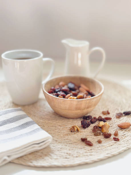 a cup of coffee ,milk and nuts in white background