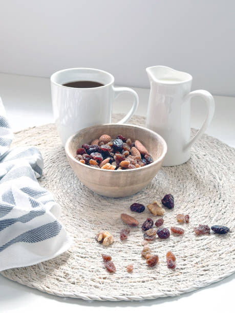 a cup of coffee ,milk and nuts in white background