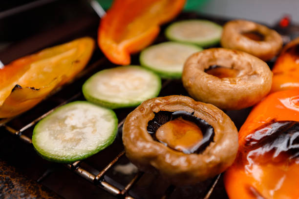 A vibrant selection of grilled vegetables including yellow and red peppers