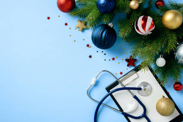 istock Christmas medical background with stethoscope, clipboard, and festive decorations on a blue surface. Ideal for healthcare holiday promotions or seasonal medical content. 2189654703
