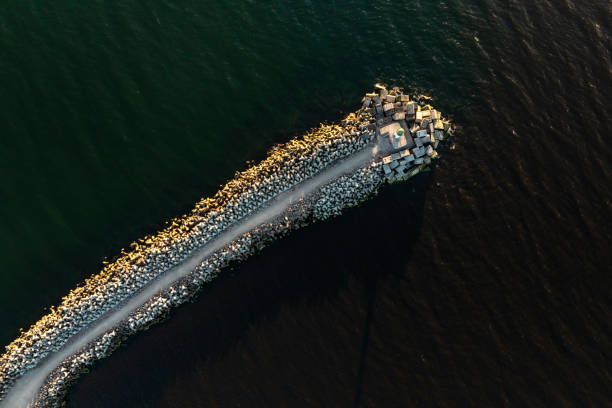 istock Aerial View of Jetty and Breakwater Extending into Dark Waters 2189654730