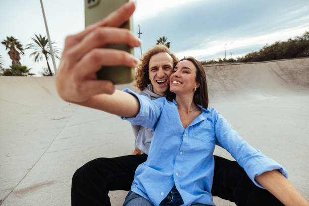 istock Young couple taking a selfie at the skatepark 2189655425