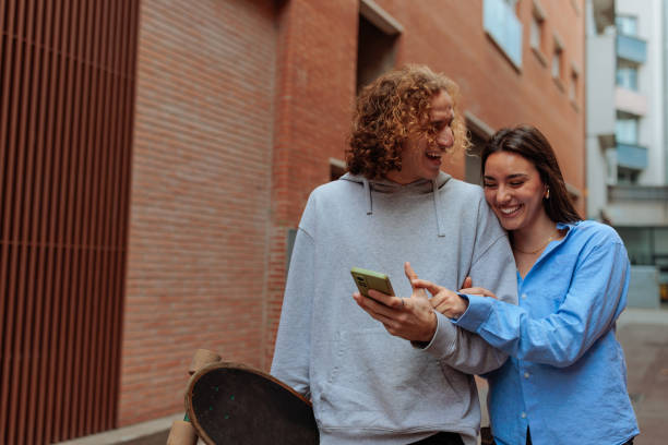 istock Young skaters sharing funny content on a smartphone and laughing together 2189655433