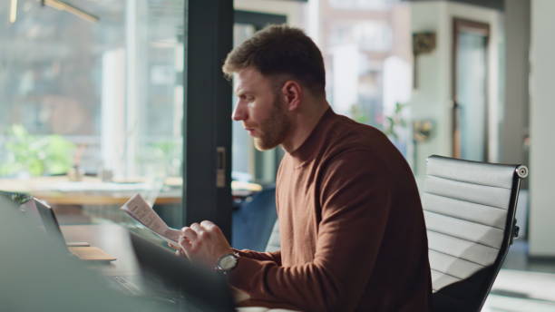 istock Serious manager reading documents in workspace closeup. Accountant working desk 2189657772