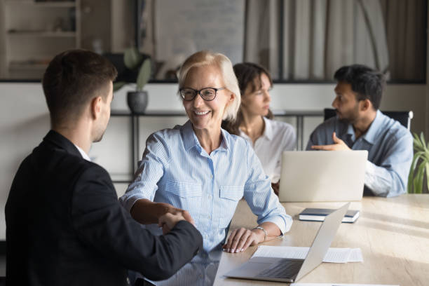 istock Older manager shake hands, greets applicant, finish job interview successfully 2189657794